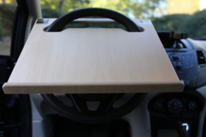 Notebook Wheeldesk car desk mounted on a car steering wheel - front view.